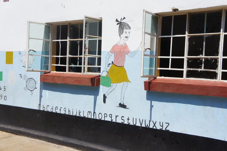 A picture of a pre-primary school shows the alphabet. 