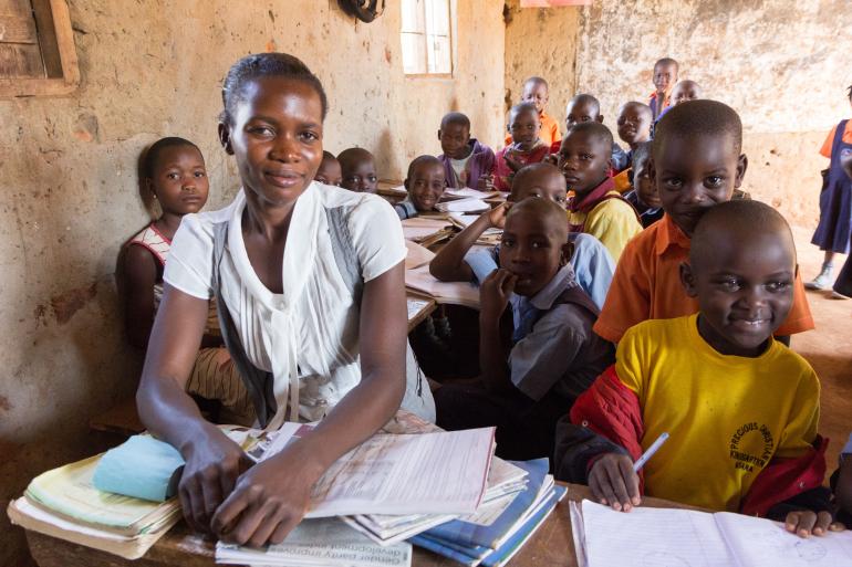 A teacher and her students in a primary school class in Uganda.
